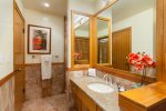 The remodeled guest bathroom features a shower, toilet and vanity